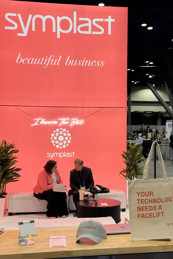 A one-on-one conversation in the Symplast booth lounge at PSTM 2026